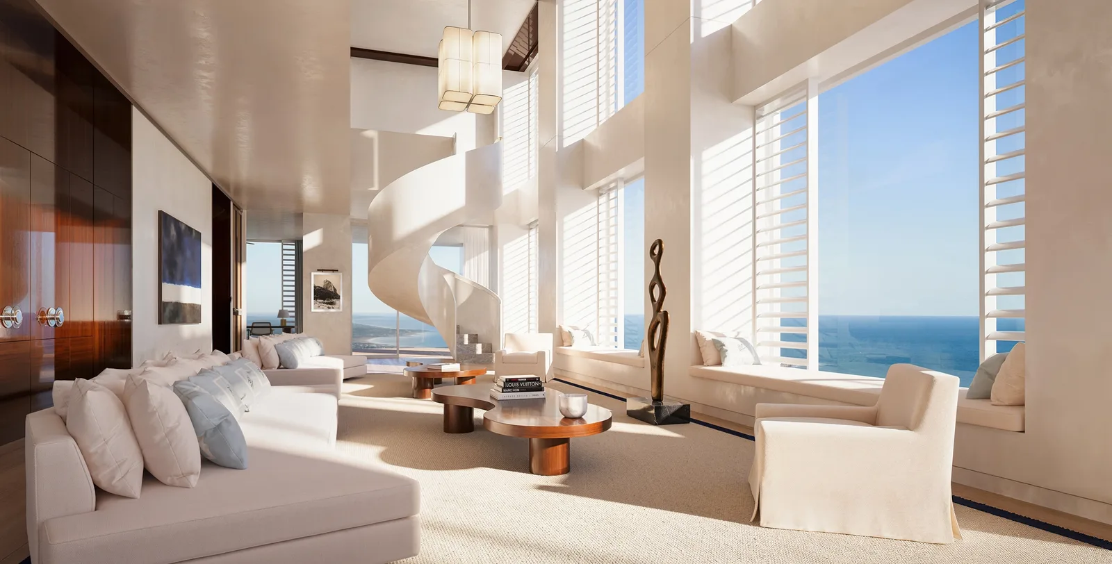 Penthouse de doble altura con escalera caracol y ventanales al océano
