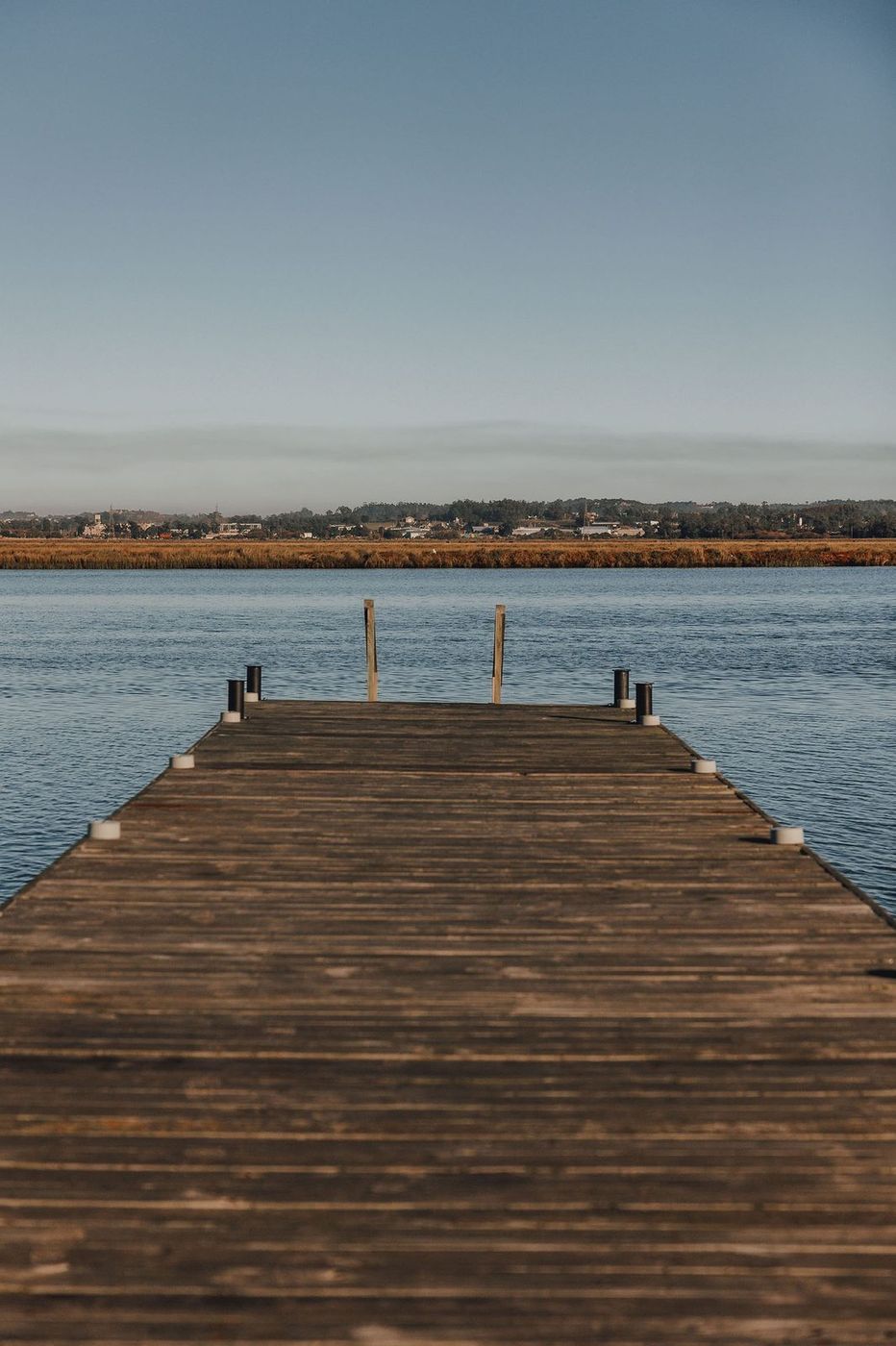 Muelle de madera adentrándose en el arroyo Maldonado