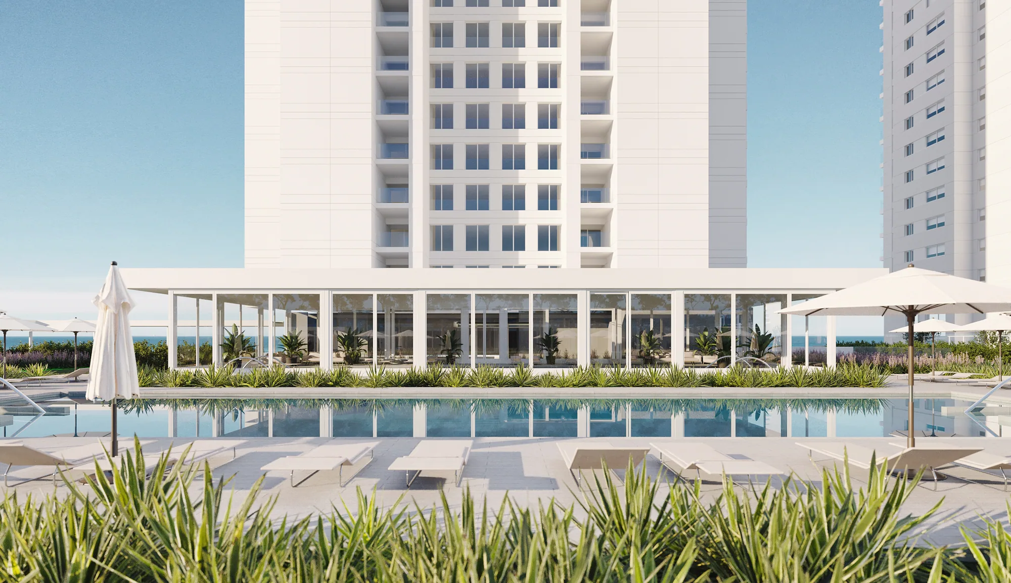 Render de la piscina exterior al pie de la torre, con sombrillas y el mar al fondo