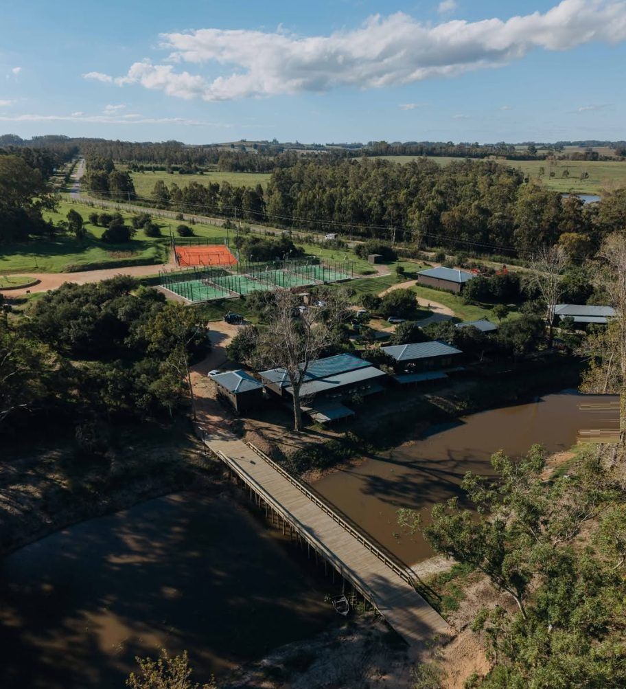 Aérea del sector del club, con las canchas y el puente de madera sobre el arroyo