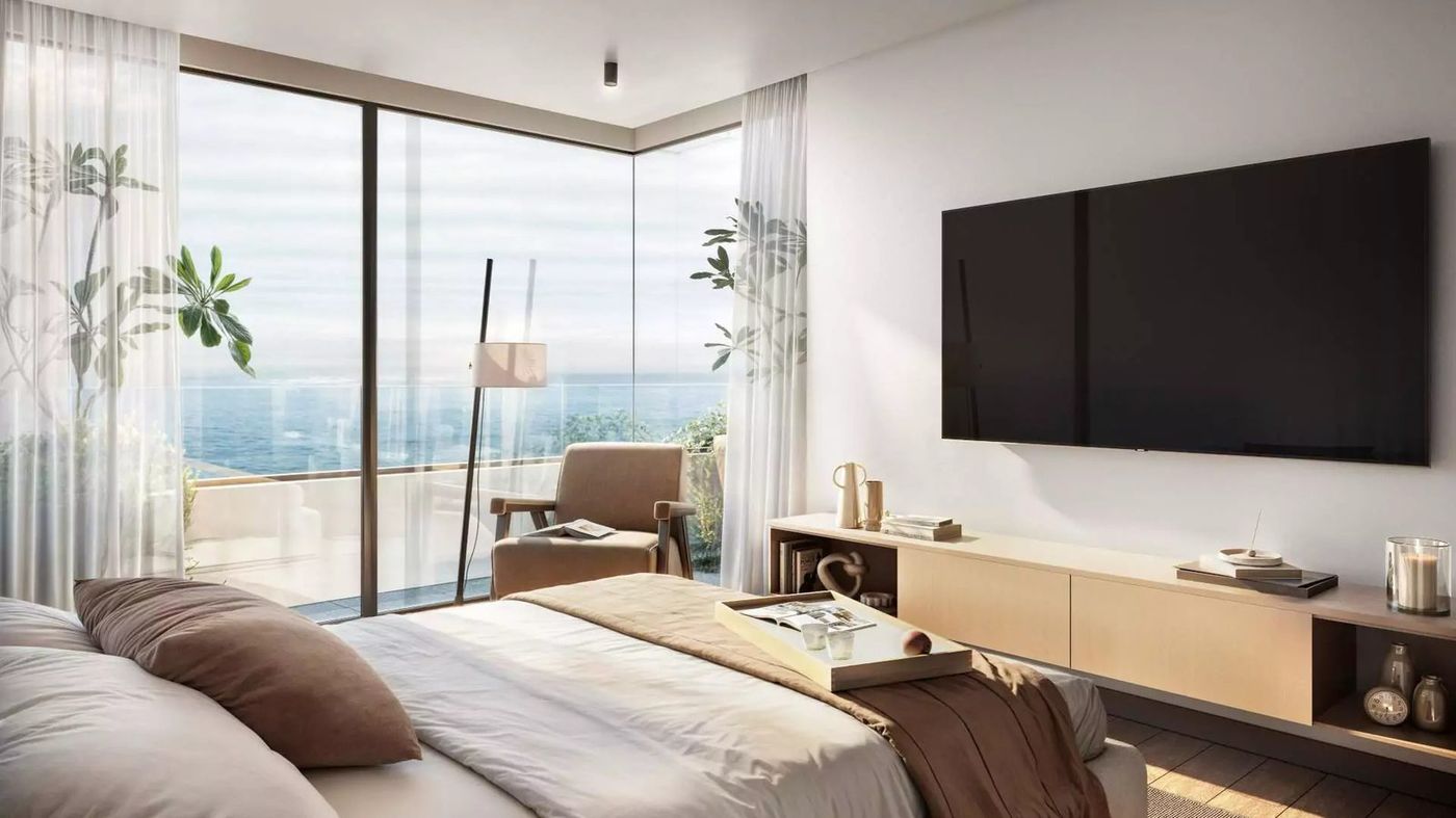 Dormitorio en suite con la esquina vidriada al mar