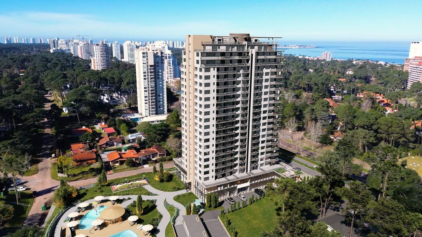 Render aéreo de la torre Rise con la piscina abajo y Punta del Este y el mar de fondo