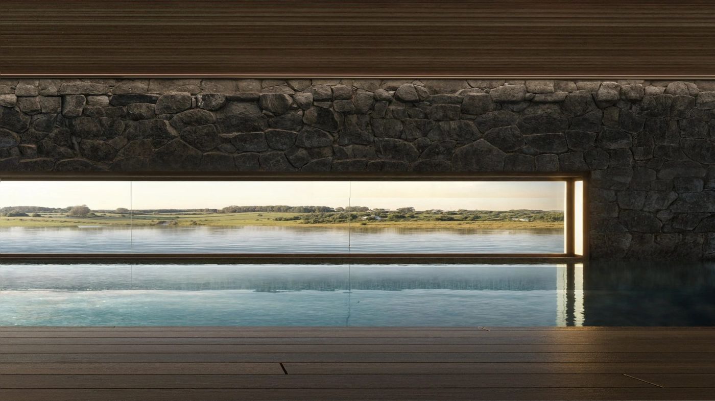 Piscina interior con muro de piedra y ventana apaisada al campo