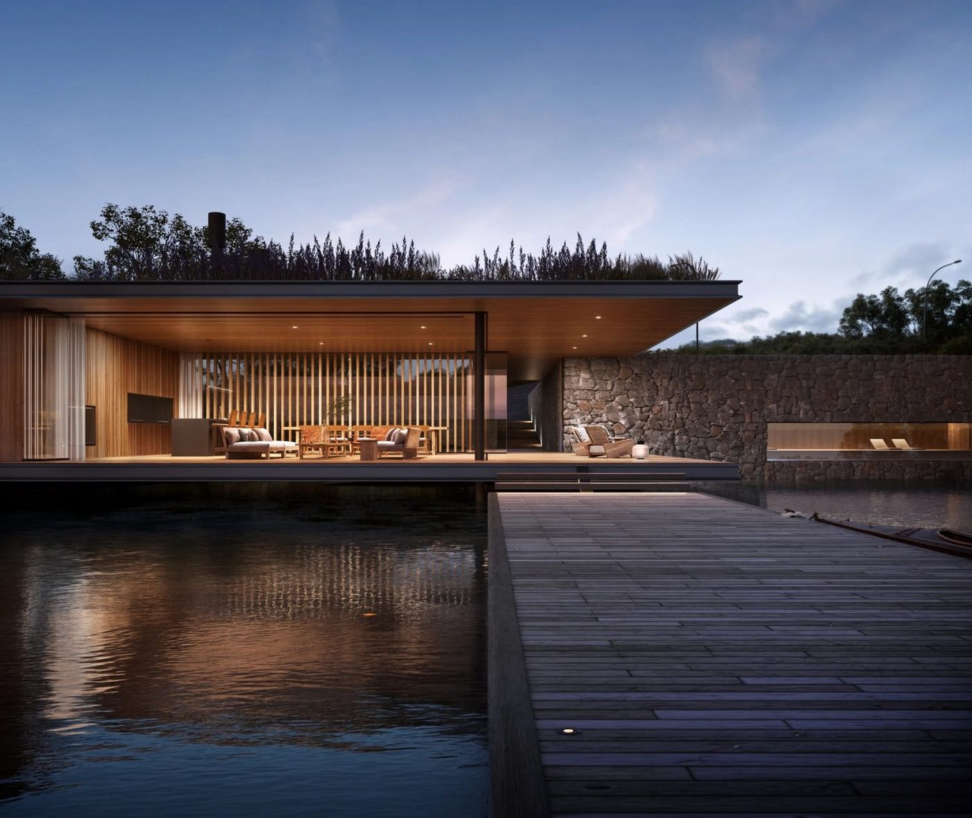 El club house al anochecer, con el muelle y el interior iluminado