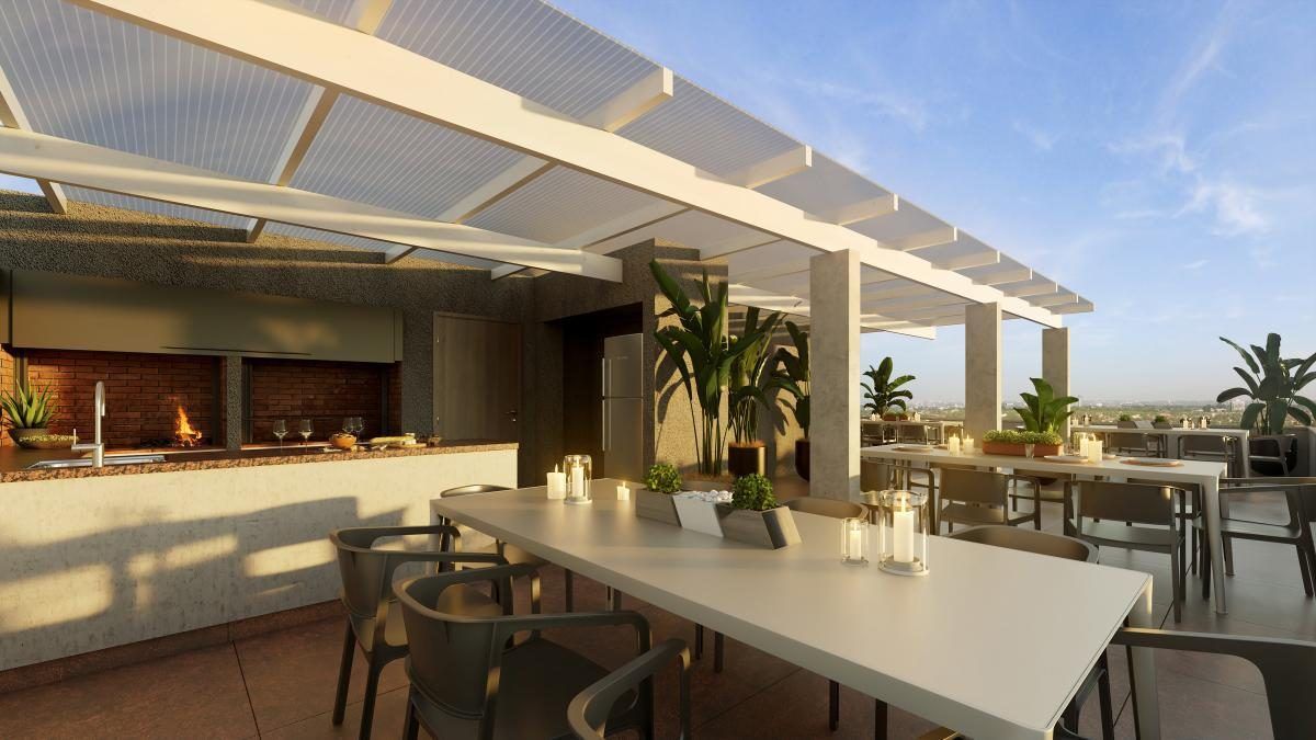 Render de la azotea con parrilleros, pérgola y mesas, al atardecer